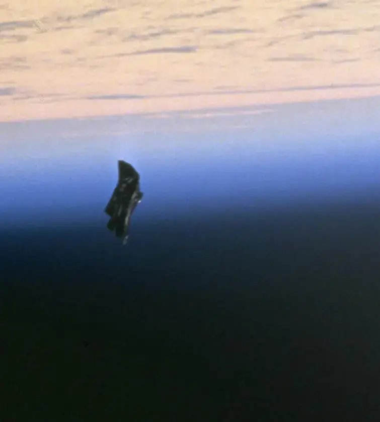 A 1998 photo from the STS-88 shuttle mission that is often shared as the 'Black Knight.' It is identified as a thermal cover that drifted away during a spacewalk.