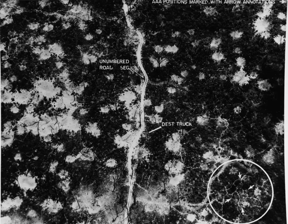 An aerial view of a road segment of the Ho Chi Minh Trail, pocked with bomb craters, during the Vietnam War.