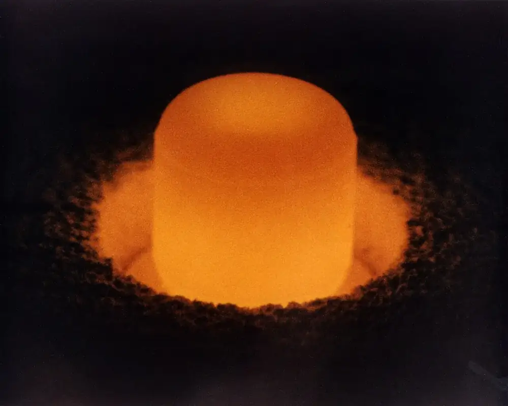 A plutonium pellet in a Department of Energy photo, shown for illustration only. It is not material from the 1945–47 experiments.