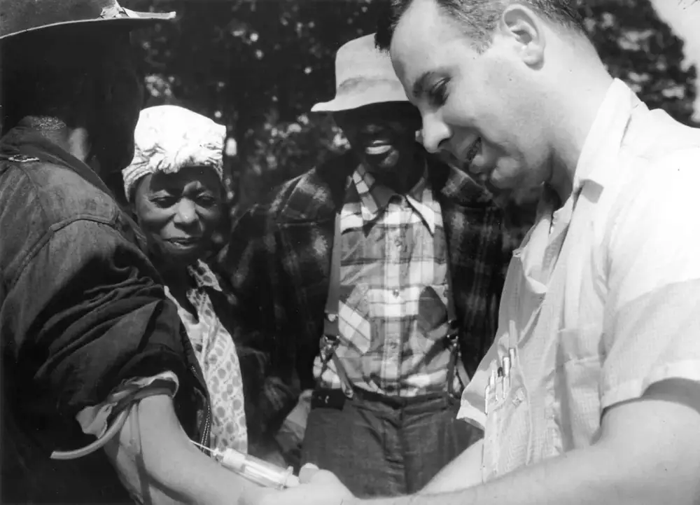 A Public Health Service doctor draws blood from a participant in the Tuskegee study.